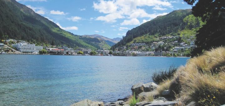 A view of Queenstown from across the lake with mountains in the background